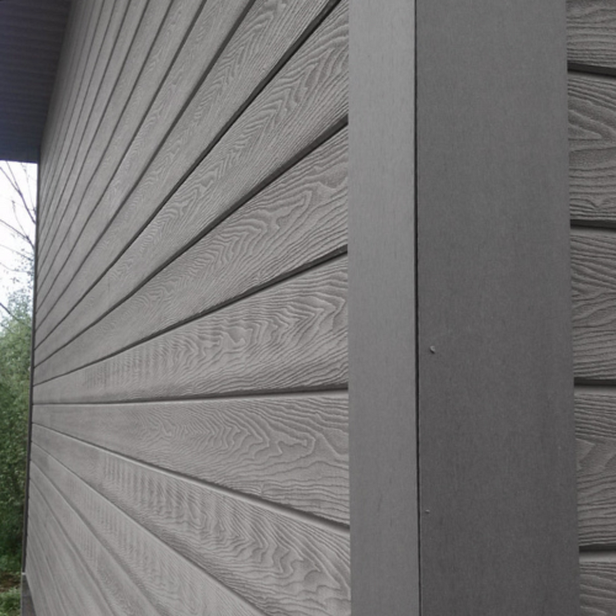 Anthracite Grey Signature woodgrain shiplap cladding with matching corner trim installed on an exterior wall
